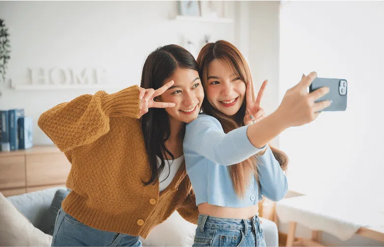 Two women taking a selfie with an iPhone 15 Pro